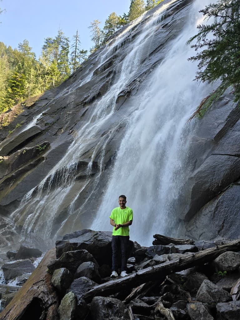 Joel at his Michigan State University graduation, holding the flag of El Salvador